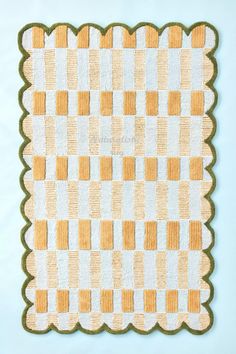 a yellow and white checkered rug on a blue background