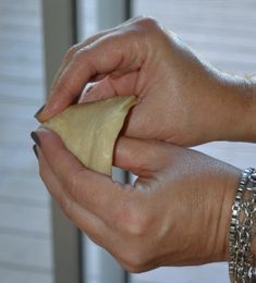 a person holding a piece of food in their hand