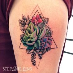 a woman's arm with a flower tattoo on the back of her shoulder and an image of succulents