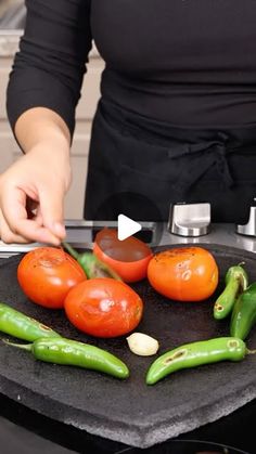 a woman is cooking some vegetables on the stove