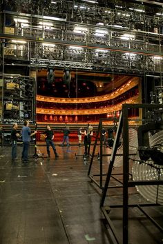 people standing in front of an empty stage