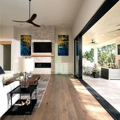 a living room filled with furniture and a ceiling fan