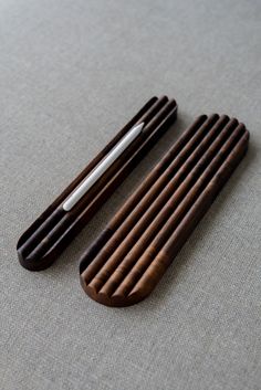 two wooden combs sitting on top of a table