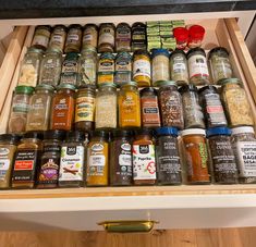 an open drawer filled with lots of different types of spices and seasonings in jars