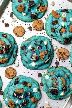 cookies with chocolate chips and oreos are on a baking sheet, ready to be eaten