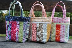 three bags sitting on top of a wooden bench