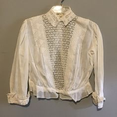 This is a small, delicate antique blouse with Victorian Style.  Buttons down the back, sleeves with matching lace as front insert and collar. Please review all photos for condition and better description. Elegant Fitted Lace Top With Broderie Anglaise, White Fitted Victorian Blouse, Fitted White Victorian Blouse, Vintage Fitted Tops With Broderie Anglaise, Vintage White Lace Trim Tops, Vintage Lace Trim Tops In Antique White, Vintage White Tops With Lace Trim, Vintage White Fitted Lace Top, Vintage Fitted White Lace Top