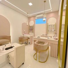 the interior of a nail salon with chairs, tables and mirrors on the wall behind the counter