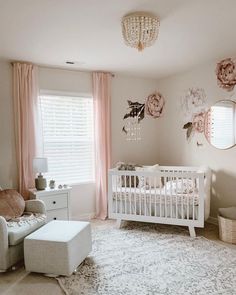 a baby's room with a crib, chair and dresser