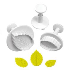 a set of three leaf shaped molds on a white background