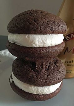 three cookies stacked on top of each other with ice cream in between them and a bottle of milk