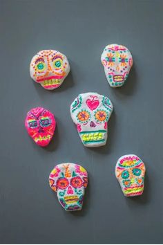 Colorful sugar skull decorations, painted with intricate, vibrant patterns on a dark gray background. Clay Sugar Skull, Sugar Skull Crafts, Crayola Air Dry Clay, Clay Projects For Kids, Sugar Skull Necklace, Do Crafts, Crafts And Activities For Kids