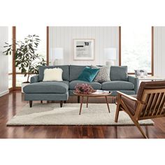 a living room with wood flooring and blue couches in it's center