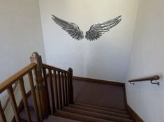 an image of stairs with wings on the wall