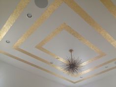 the ceiling in this room is painted gold and white