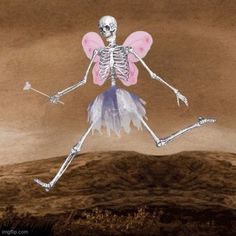 a skeleton is flying through the air with a pink and white wings on it's back