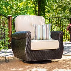 a chair sitting on top of a patio next to a fence