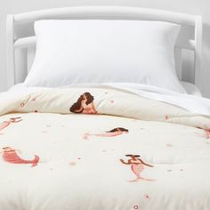 there is a bed with mermaids on it