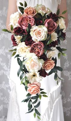 a bride holding a bouquet of flowers in her hands