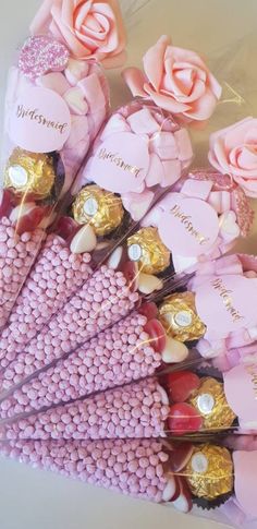 pink roses and chocolates are arranged in a bouquet