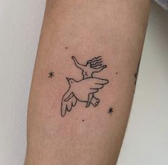 a tattoo on the arm of a woman with an eagle flying through the sky and stars