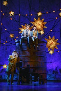 two people sitting on top of a tower with stars