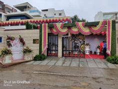 an entrance to a building decorated with flowers and greenery for a wedding or other function