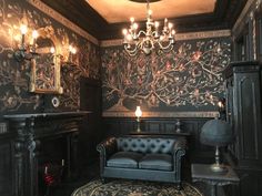 a living room with a couch, chair and chandelier