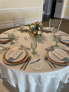 the table is set with place settings and silverware for an elegant dinner party or reception