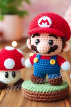 a crocheted mario and mushroom figurine sitting on top of a wooden table