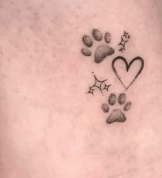 a dog's paw and heart tattoo on the side of his chest, with stars