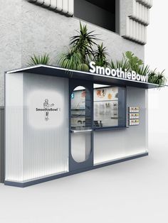 a white and blue kiosk with plants on top