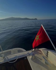 a flag on the back of a boat in the water