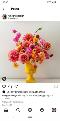 a yellow vase filled with lots of flowers on top of a white table next to an instagram post