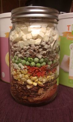 a jar filled with lots of food sitting on top of a table