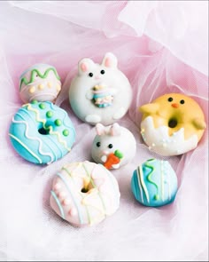 there are many donuts that have frosting and designs on them, including one with an animal