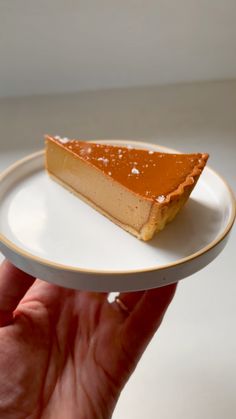 a piece of pie sitting on top of a white plate with gold trim around it