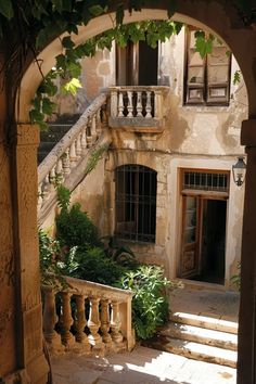 an old building with stairs leading up to the second floor and another door on the first floor