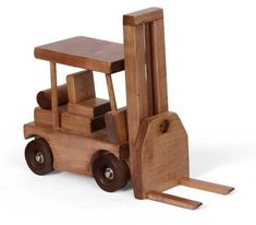 a wooden toy forklift with a piece of wood next to it