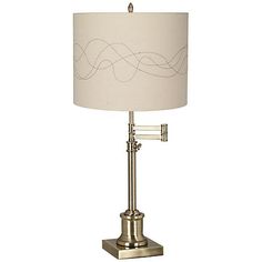 a table lamp with a white shade on it and a silver base, sitting on a white background