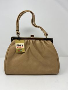 Vintage 70s Great American by Kmart soft silkie vinyl handbag in tan color. Deadstock with original tags 15" height x 14" wide Free shipping This is a vintage treasure! As always, This is one of my latest rare finds! I've been searching for 70's, 80's & 90's styled outfits sets in a good condition for a while. I was very surprised when I found this set in a mint condition!! About the outfit: - Mint condition - Unique and rare find. You will stand out with this set in a good and fashionable way! 70s Accessories Purse, Vintage Handbags From 70s, 70s Bags, Outfit Mint, Styled Outfits, Pretty Skirts, Tan Color, Vintage 70s, Mint Condition