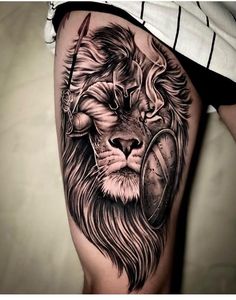 a lion with a magnifying glass tattoo on his thigh is seen in this image