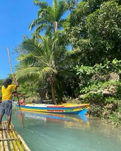 a man standing on top of a wooden raft