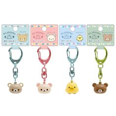 four key chains with different designs and animals hanging from it's sides, all in various colors