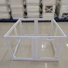 a large white window sitting on top of a floor next to pallets of paper