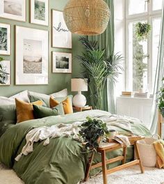 a bedroom with green walls and pictures on the wall