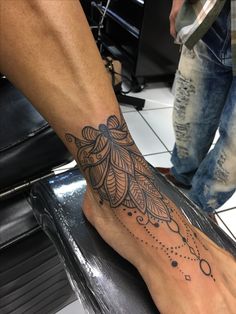 a person has a tattoo on their foot