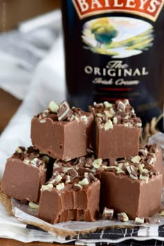 chocolate fudges stacked on top of each other next to a bottle of bailey's