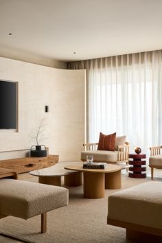 a living room filled with furniture and a flat screen tv mounted to the side of a wall