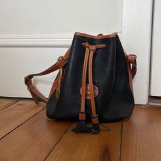 Pretty Navy Blue And Tan Vintage Dooney And Burke Leather Bag With Original Hang Tags And Fabric Tag Inside. Some Wear On Piping On The Bottom Of Bag And A Light Discoloration On Front Under Straps. See Photos. Still Such An Awesome Vintage Piece! Dooney And Burke, Bucket Purse, Bags Vintage, Fabric Tags, Dooney & Bourke Bags, Dooney Bourke, Hang Tags, Piping, Leather Bag